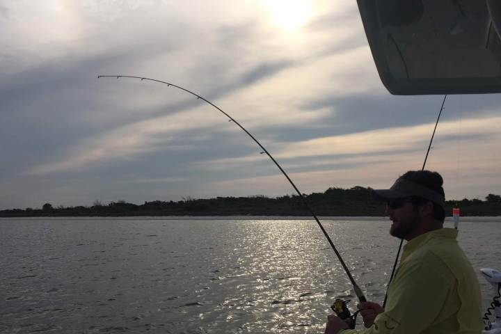 Man fishing off boat