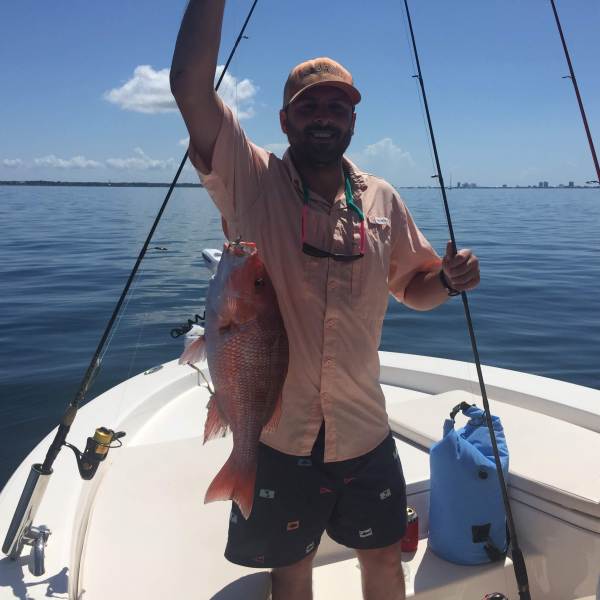 Man holding up big red snapper caught off coast of Florida
