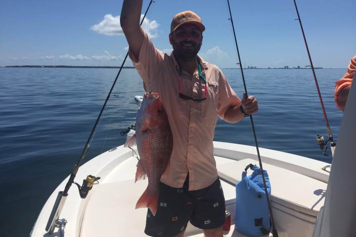 Man holding up big red snapper caught off coast of Florida