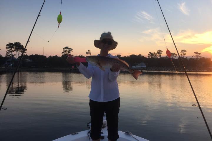 Woman fishing during sunset