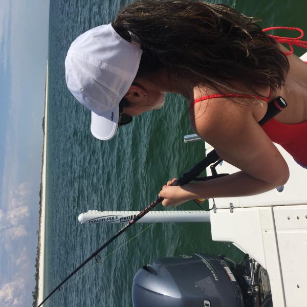 Woman fishing off back of the boat in Destin