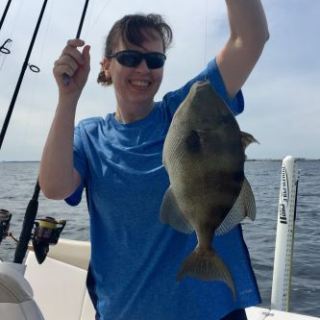 Lady holding up fish she caught